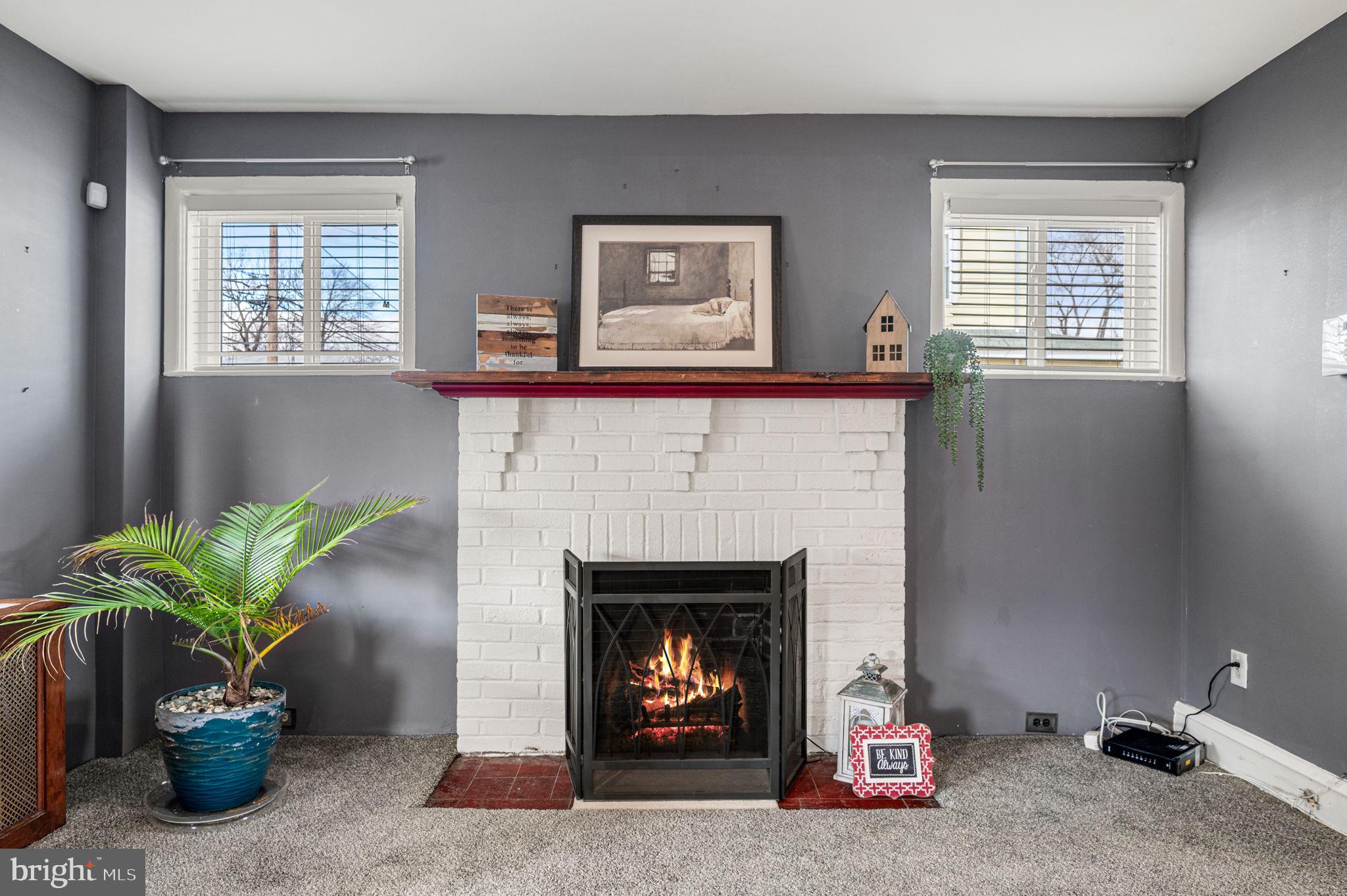 235 Ardmore Avenue Upper Darby, PA 19082 - Photo 7 of 23 a living room with furniture and a fireplace