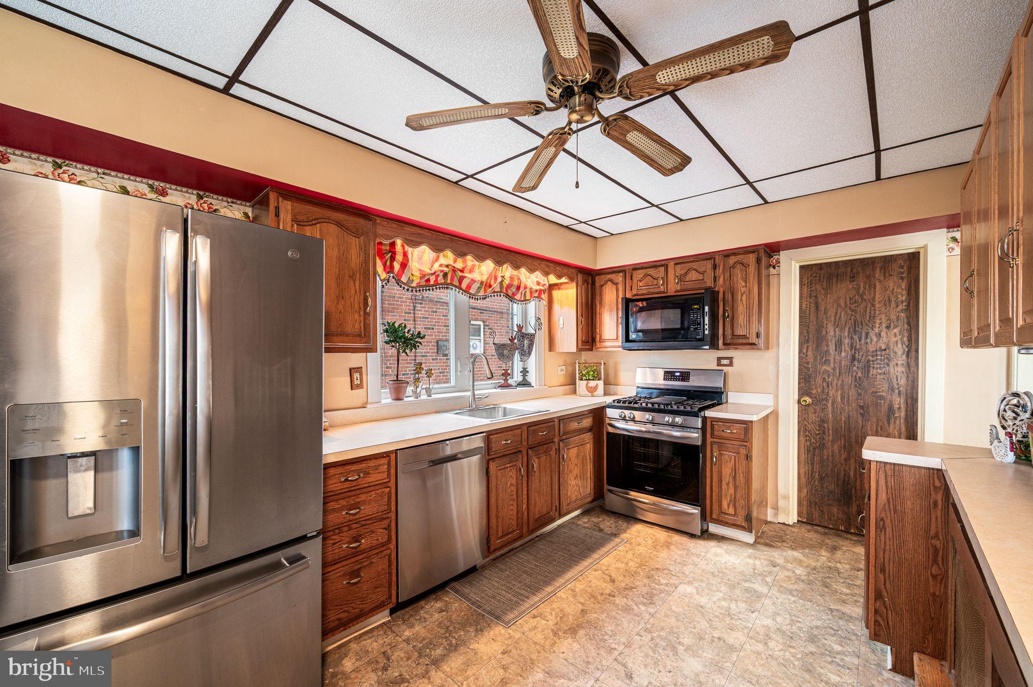 235 Ardmore Avenue Upper Darby, PA 19082 - Photo 10 of 23 a kitchen with stainless steel appliances granite countertop a refrigerator and a stove top oven