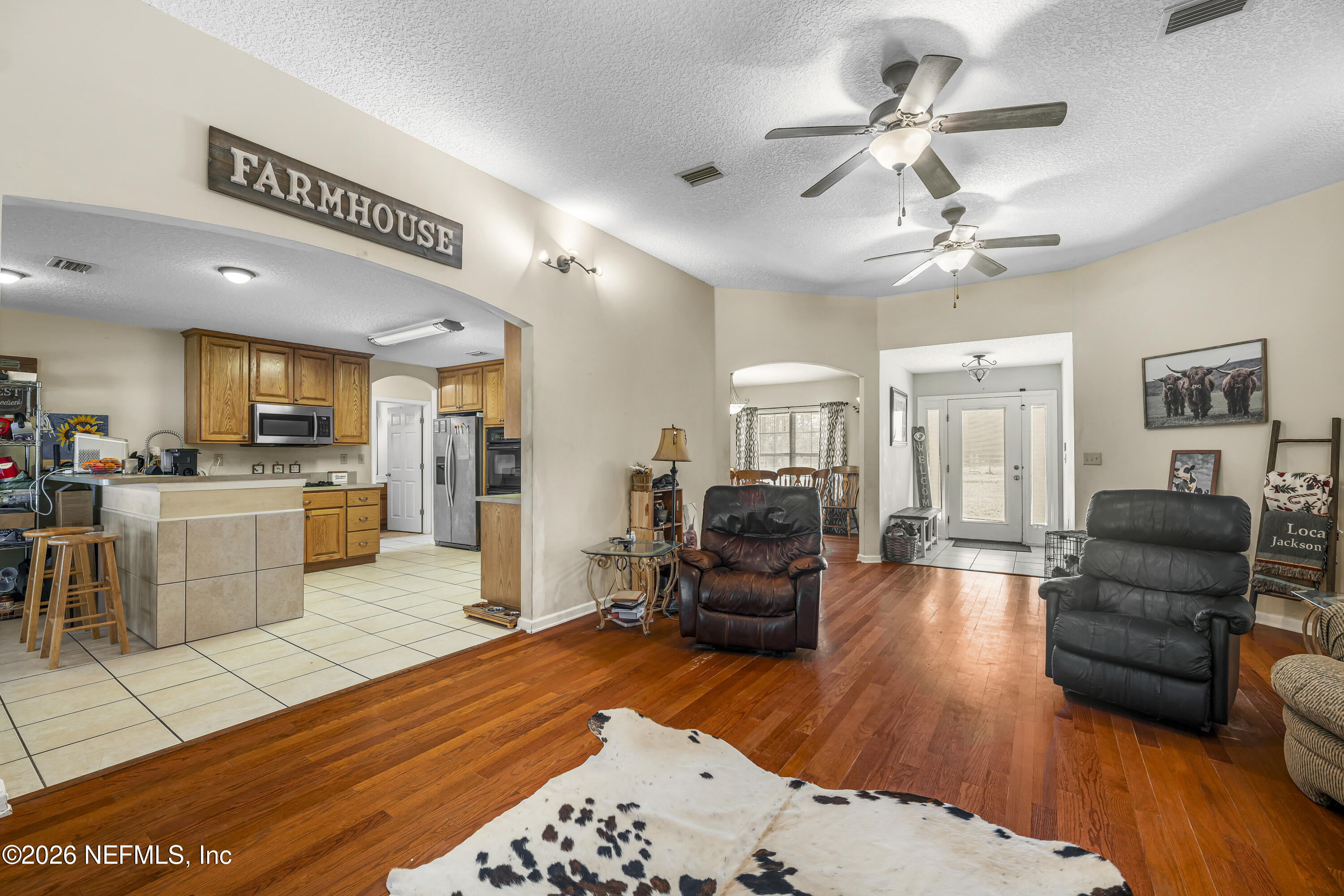 1725 Davidson Farm Road Jacksonville, FL 32218 - Photo 19 of 53 a living room with furniture kitchen view and a wooden floor