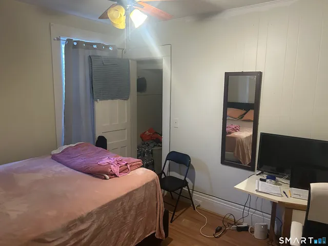 a bedroom with a bed and a desk