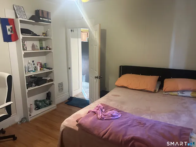 a bedroom with a bed and a book shelf