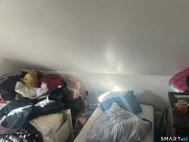 a bed room with a bed and a tv