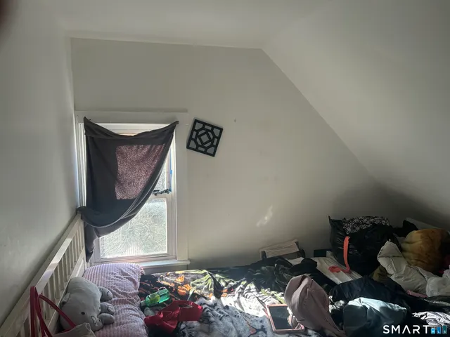 a living room with furniture and a painting on the wall