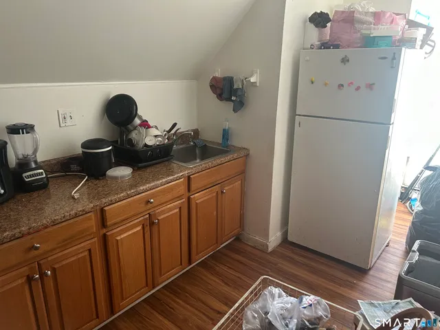 a kitchen with a refrigerator and a stove