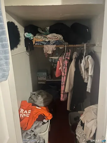 a view of walk in closet with clothes and shoes