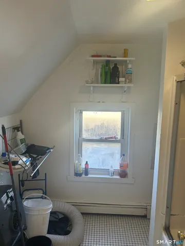 a bathroom with a toilet a sink and window