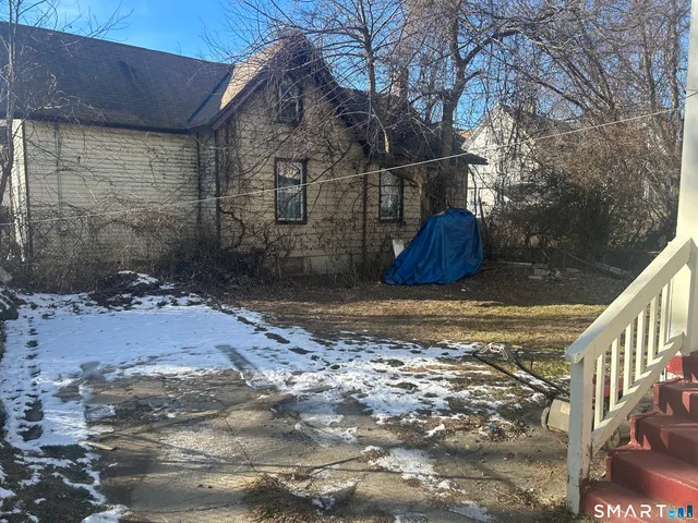 a view of a brick house with a yard