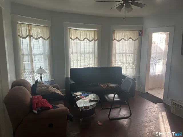 a living room with furniture and two window