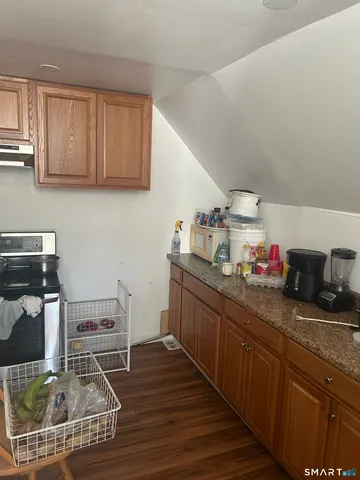 a kitchen with sink cabinets and stove top oven