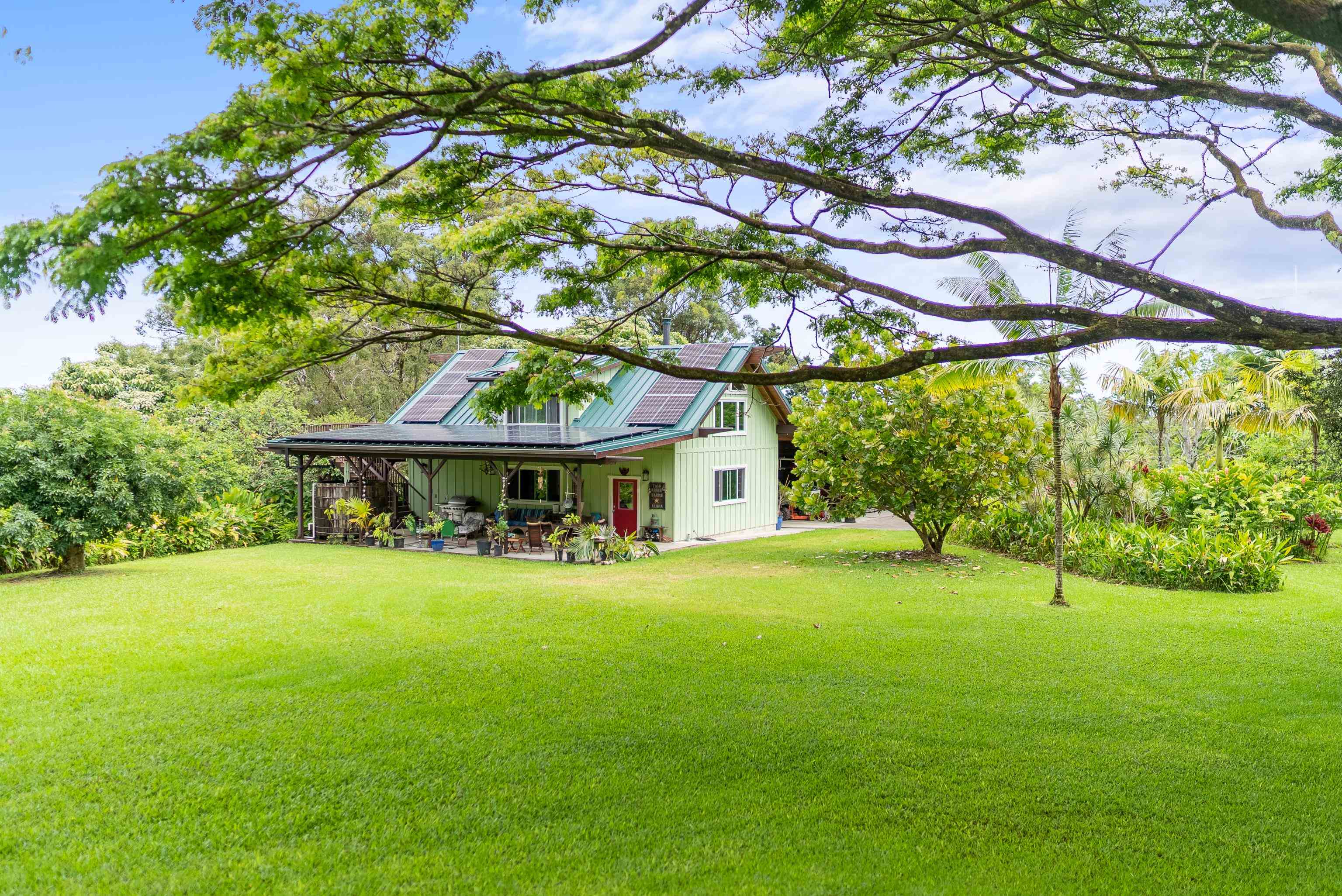 a view of house with yard and outdoor seating
