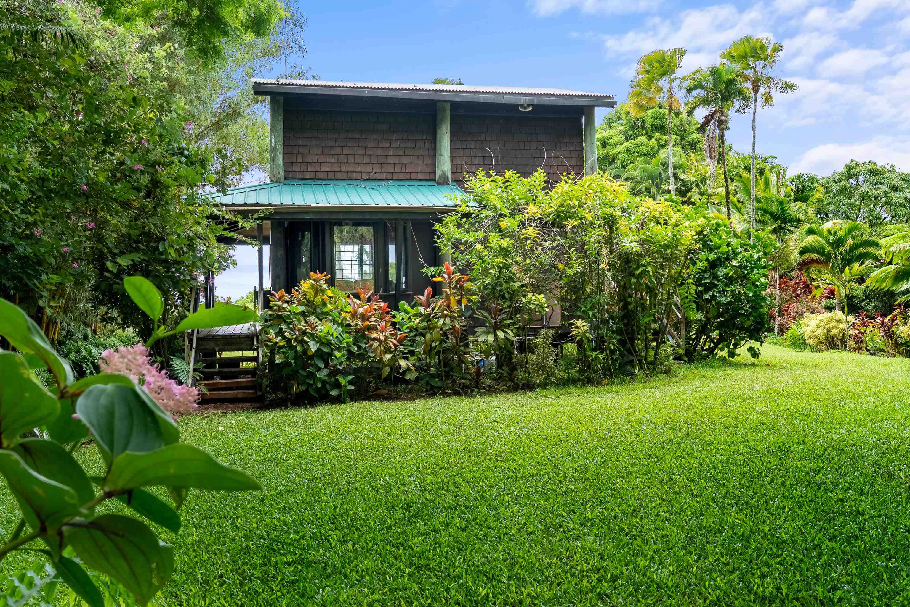 1600 Lower Nahiku Road Hana, HI 96713 - Photo 11 of 23 a view of a house with a yard and plants