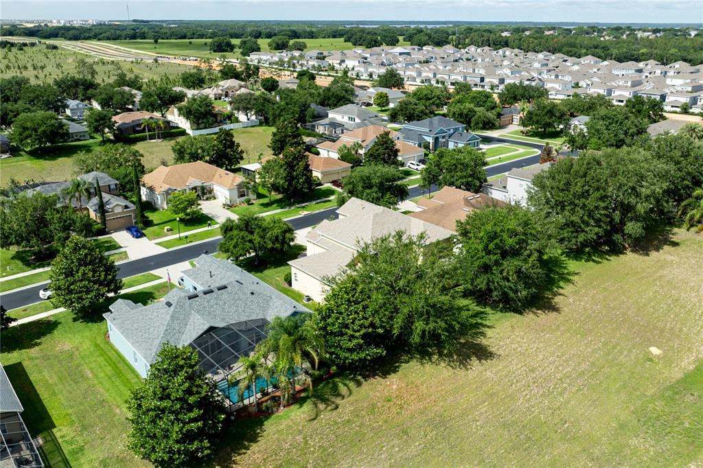 2718 Knightsbridge Road Clermont, FL 34711 - Photo 69 of 72 an aerial view of residential houses with outdoor space and trees