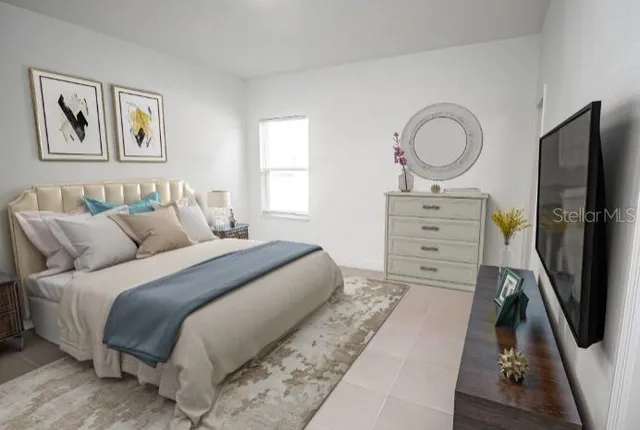 a bedroom with a bed closet and flat tv screen