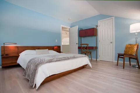 a bedroom with a bed and a chair