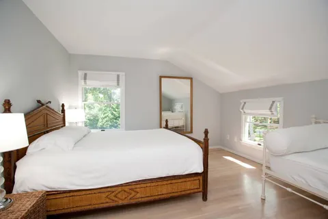 a bedroom with a bed and window