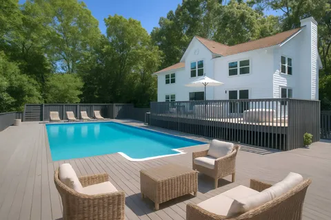 a view of a patio with couches chairs and a yard