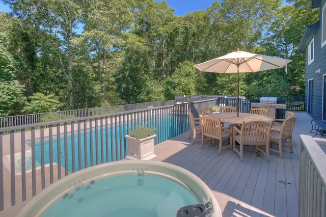 swimming pool view with a seating space