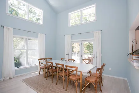 a view of a dining room with furniture and windows