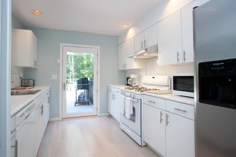 a kitchen with cabinets oven and a sink