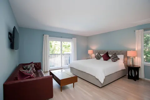 a bedroom with a bed and a couch