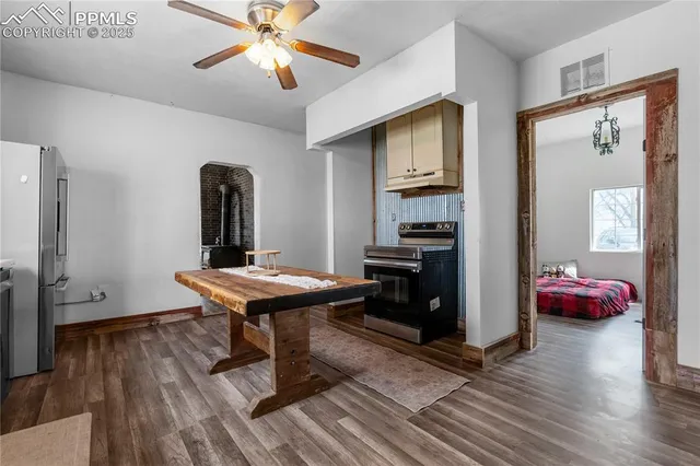 a kitchen with a table chairs refrigerator and cabinets