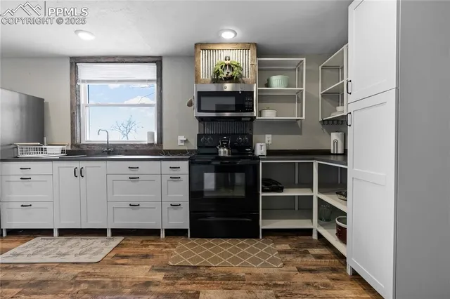 a kitchen with stainless steel appliances granite countertop a stove and a sink