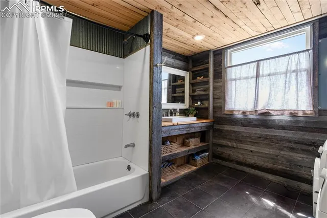 a bathroom with a sink a toilet and a shower
