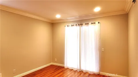 a view of a room with wooden floor