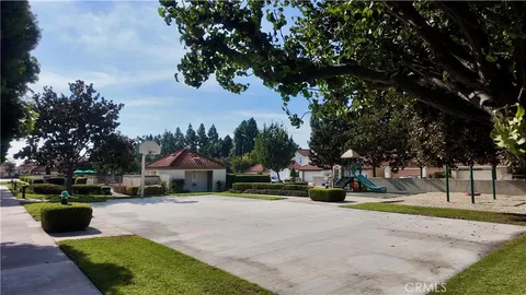 a view of street with houses and trees in the background