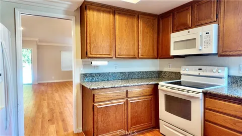 a kitchen with granite countertop cabinets stainless steel appliances and a sink