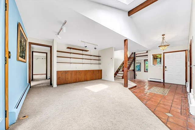 a view of a livingroom with furniture and stairs