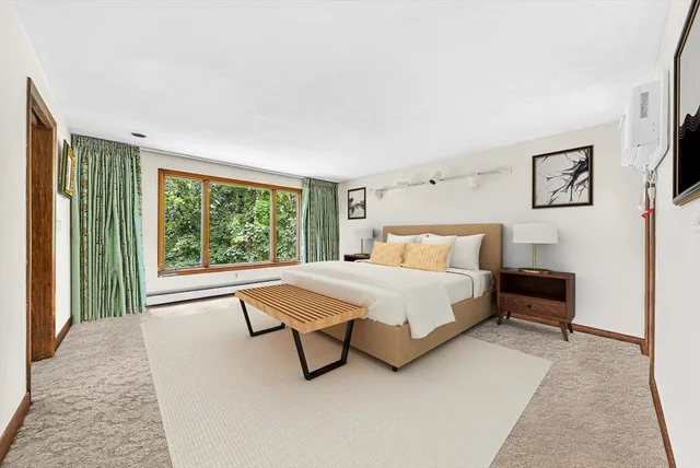 a bedroom with a bed and a large window