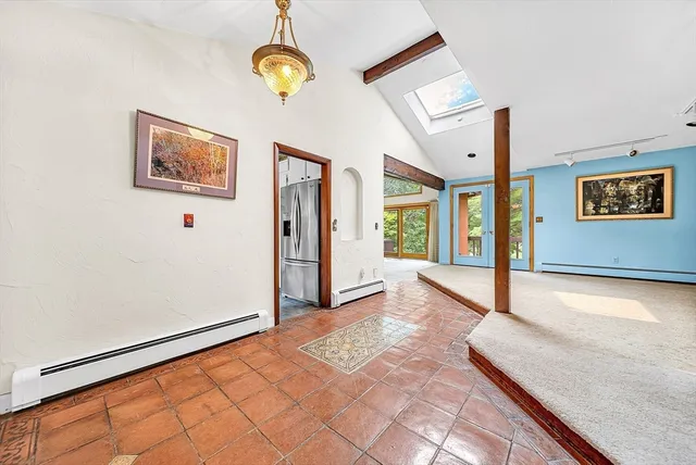 a view of a hallway with entryway wooden floor and front door