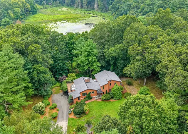 a view of a house with a yard and lake