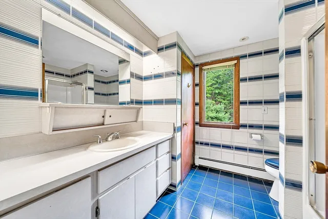 a kitchen with a sink window and cabinets