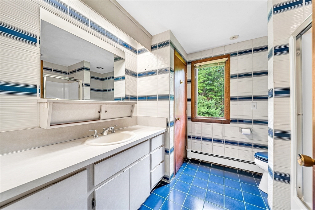 57 South Street Natick, MA 01760 - Photo 24 of 36 a kitchen with a sink window and cabinets