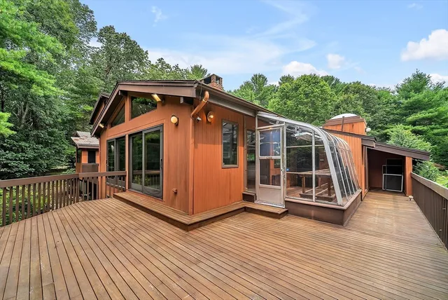 an aerial view of a house with a yard and large trees