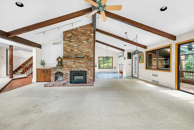 a view of a livingroom with an empty space and a fireplace