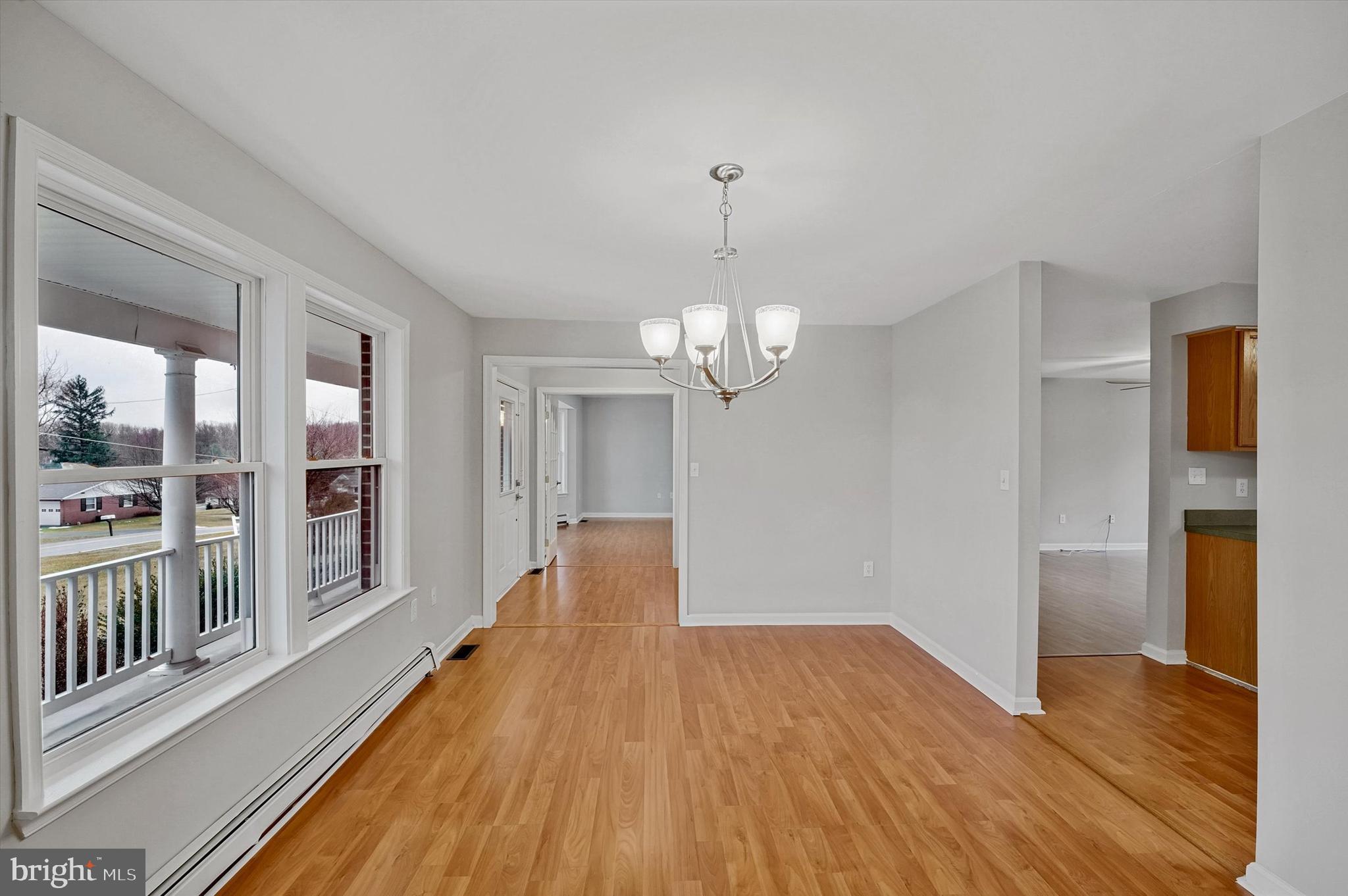 7510 Old Receiver Road Frederick, MD 21702 - Photo 12 of 57 a view of a hallway with wooden floor and chandelier