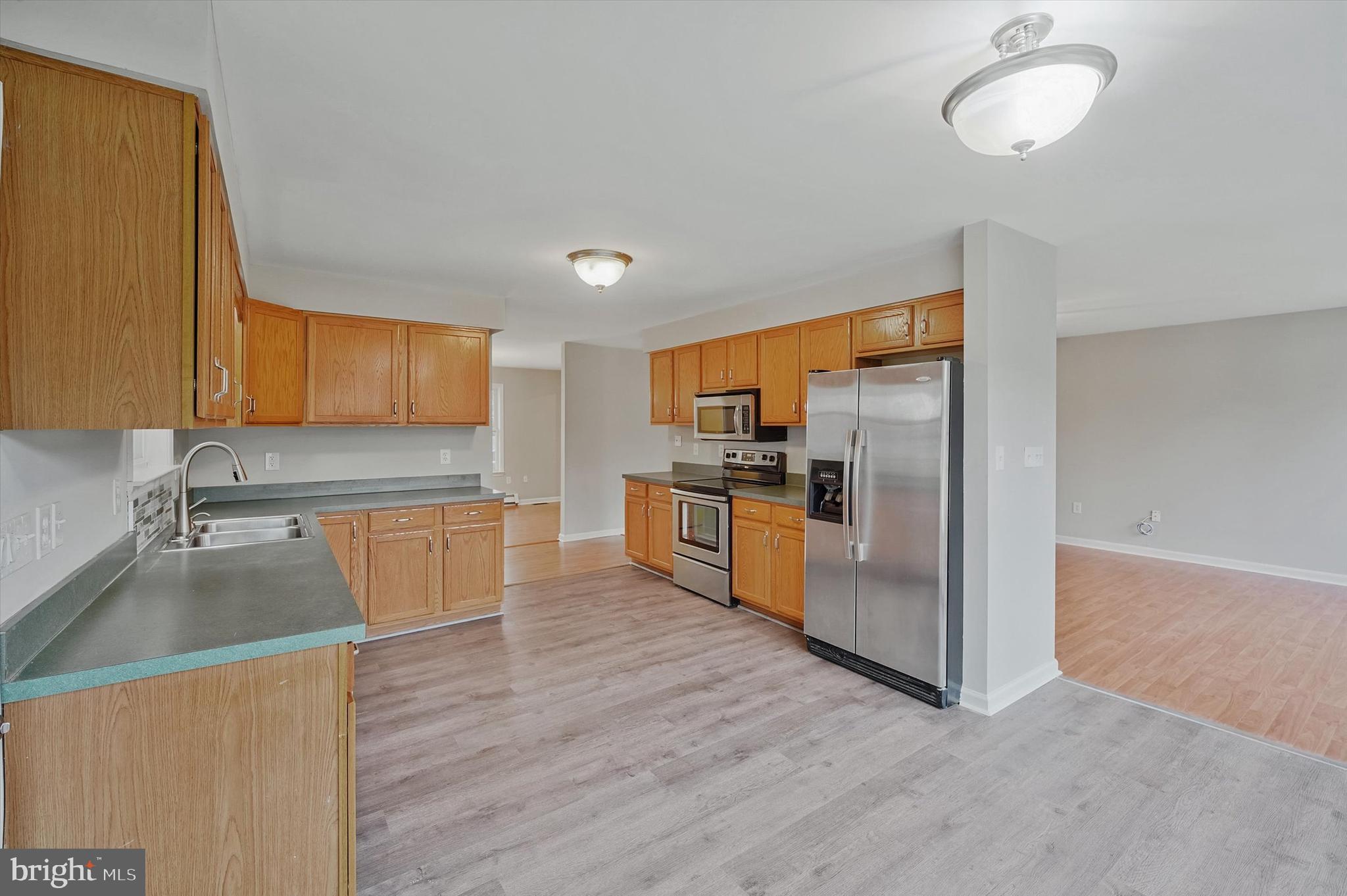 7510 Old Receiver Road Frederick, MD 21702 - Photo 17 of 57 a kitchen with stainless steel appliances granite countertop a refrigerator a stove top oven a sink and dishwasher