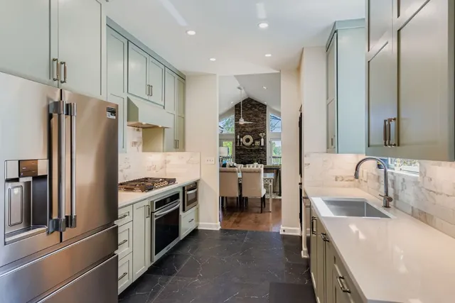 a kitchen with stainless steel appliances a refrigerator sink and stove