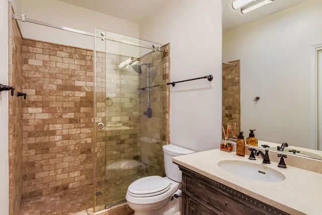 a bathroom with a sink toilet and shower