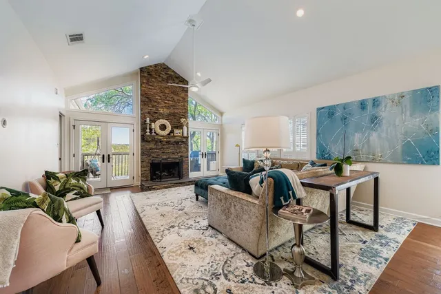 a living room with fireplace furniture rug and a fireplace