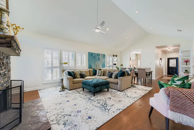 a living room with furniture potted plant and a window