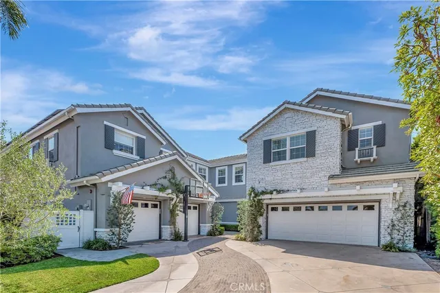 a front view of a house with a garden and yard