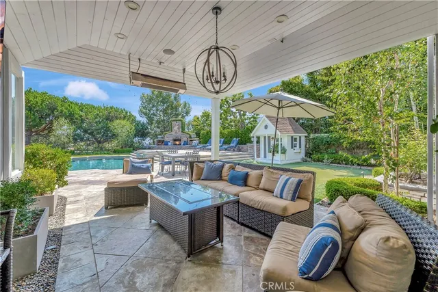 a swimming pool with outdoor seating and yard