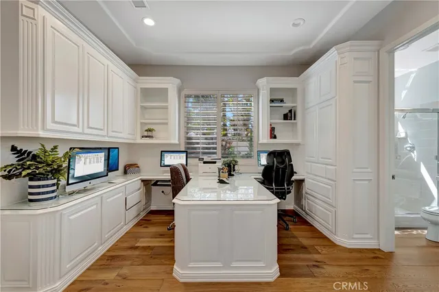 a view of a balcony with two chairs and wooden fence