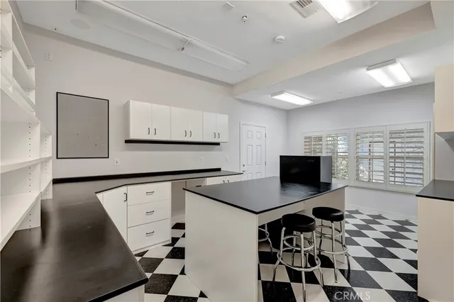a living room with furniture a chandelier and a fireplace