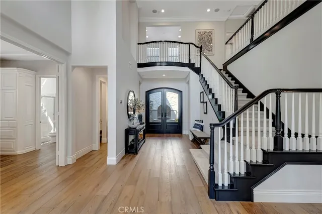 a view of staircase with lots of frames and frames on a chandelier
