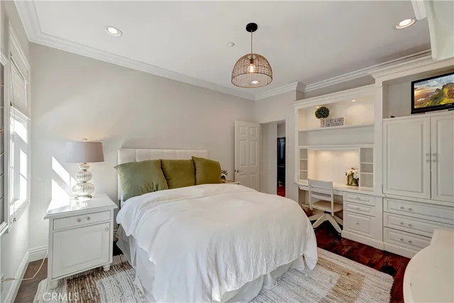 a bed room with a bed mirror and a window